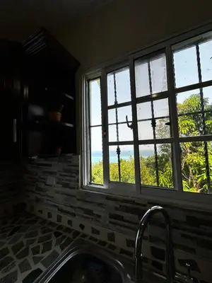 a kitchen with a sink and a window with a view at Casa Vista Mar, Los Patos, Barahona - 4x4 or All Terrain Vehicle to Access Property in Los Patos