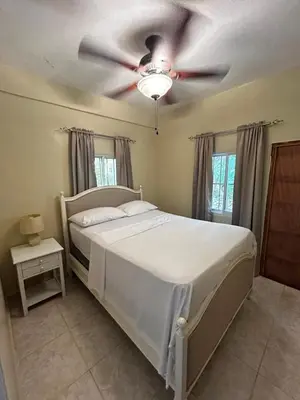 a bedroom with a bed with a ceiling fan at Casa Vista Mar, Los Patos, Barahona - 4x4 or All Terrain Vehicle to Access Property in Los Patos