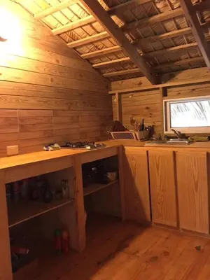 a kitchen with a counter in a wooden cabin at Mango House Detox studio in Cabarete