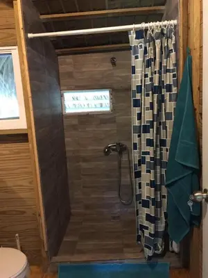 a bathroom with a shower with a shower curtain at Mango House Detox studio in Cabarete