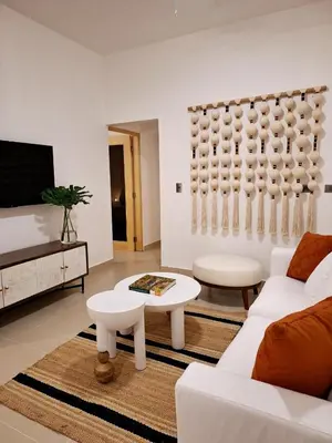 a living room with a white couch and a table at Atlantic Paradise Cabrera in Arroyo Azul