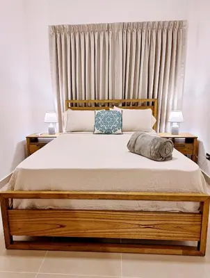 a bedroom with a large bed with two lamps at Atlantic Paradise Cabrera in Arroyo Azul