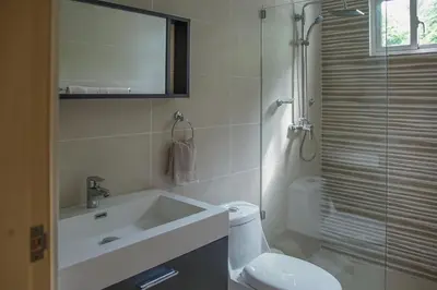 a bathroom with a toilet and a sink and a shower at Atlantic Paradise Cabrera in Arroyo Azul