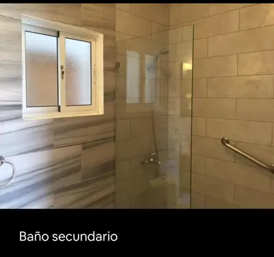 a bathroom with a shower with a glass door at Cadaqués, Bayahibe, República Dominicana in Bayahibe