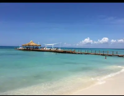 a pier in the ocean with a beach at Cadaqués, Bayahibe, República Dominicana in Bayahibe