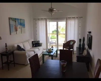 a living room with a couch and a table at Cadaqués, Bayahibe, República Dominicana in Bayahibe