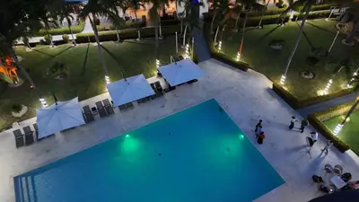 an overhead view of a swimming pool with umbrellas at El Colibri Hotel in Sosúa