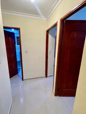 a room with two doors and a tile floor at Posada del caribe in La Cana