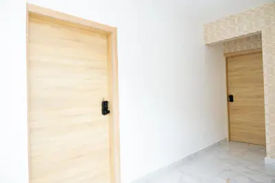 a pair of wooden doors in a room at Apartahotel Señorial in Higuey