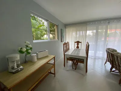 a kitchen and dining room with a table and chairs at 2 BR & 1WR Suite at Villa Costa Verde near Playa Cofresi, Puerto Plata with a pool, balcony, and a rooftop terrace in San Felipe de Puerto Plata