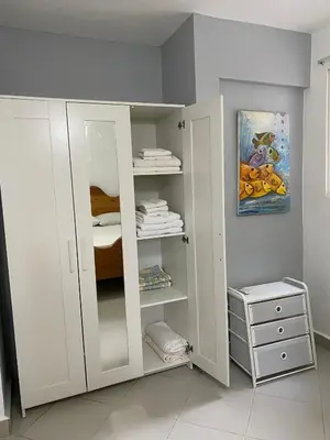 a white cabinet in a room with a bed at 2 BR & 1WR Suite at Villa Costa Verde near Playa Cofresi, Puerto Plata with a pool, balcony, and a rooftop terrace in San Felipe de Puerto Plata