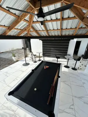 a pool table sitting on top of a patio at LEVEL suites #7 in Sosúa
