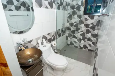 a small bathroom with a toilet and a sink at The American Dream in Jarabacoa