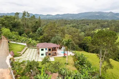 an aerial view of a house in a field at The American Dream in Jarabacoa