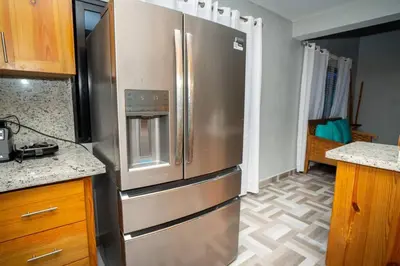 a kitchen with a large stainless steel refrigerator at The American Dream in Jarabacoa