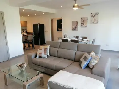 a living room with a couch and a table at Sabrina Plaza Residence in Las Terrenas