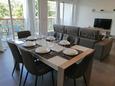 a dining room with a table with plates and wine glasses at Sabrina Plaza Residence in Las Terrenas