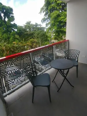 two chairs and a table on a balcony at Sabrina Plaza Residence in Las Terrenas