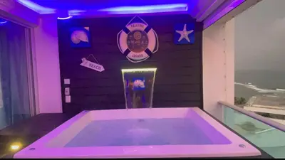 a hot tub in a room with purple lights at Beachfront Apartment with Jacuzzi in Juan Pedro