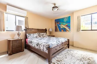 a bedroom with a bed and a painting on the wall at Club Residential, Sosua in Sosúa