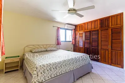 a bedroom with a bed and a ceiling fan at Club Residential, Sosua in Sosúa