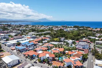 an aerial view of a city and the ocean at Club Residential, Sosua in Sosúa