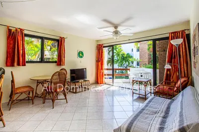 a living room with a bed and a table and chairs at Club Residential, Sosua in Sosúa