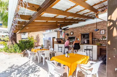 a patio with tables and chairs and a bar at Club Residential, Sosua in Sosúa