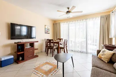 a living room with a couch and a dining room at Club Residential, Sosua in Sosúa