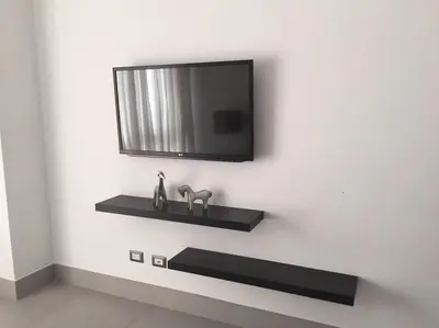 a wall with a shelf and a tv on a wall at Dream Rooftop Downtown View in Santo Domingo