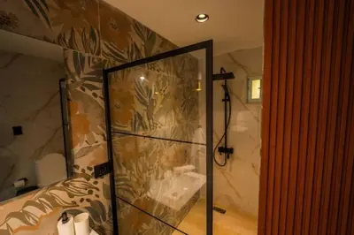 a shower with a glass door in a bathroom at Villa Hermosa en Metro Country Club Juan Dolio in Juan Dolio