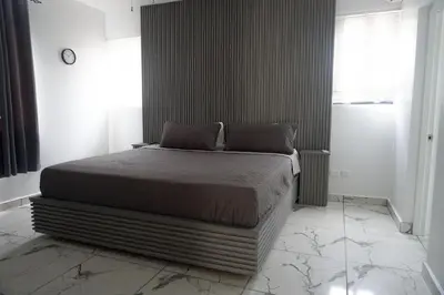 a bedroom with a large bed in a room at LEVEL suites premium in Sosúa