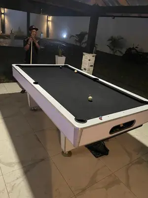 a man standing next to a pool table at LEVEL suites premium in Sosúa