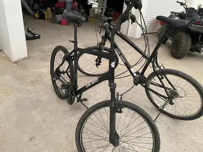 a bike chained to a pole in a garage at LEVEL suites premium in Sosúa