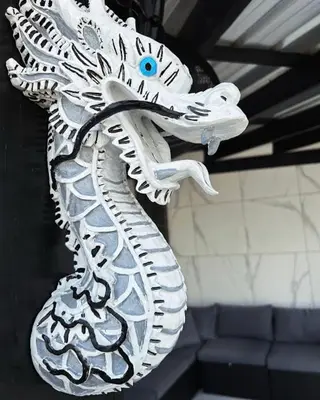 a white dragon statue hanging on a wall at LEVEL suites #8 in Sosúa