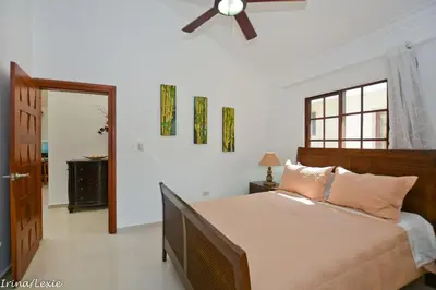 a bedroom with a bed and a ceiling fan at Rosa Hermosa Penthouse | Vista Piscina • Bávaro in Punta Cana
