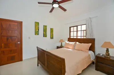 a bedroom with a bed and a ceiling fan at Rosa Hermosa Penthouse | Vista Piscina • Bávaro in Punta Cana