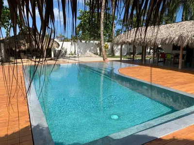 a swimming pool with blue water in a resort at La casita del sol in Las Terrenas