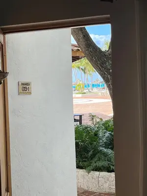 a door with a sign that reads guest os at Bayahibe Cadaques Caribe Apartment in Bayahibe