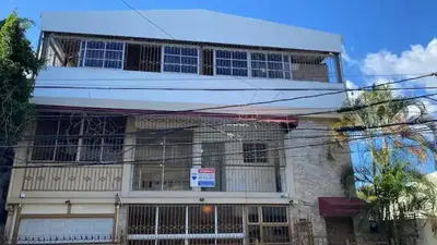 a building with a lot of windows on top of it at Close in Santo Domingo