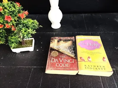 two books are sitting on a table with plants at Linkzup Playa Laguna Villa in Sosúa