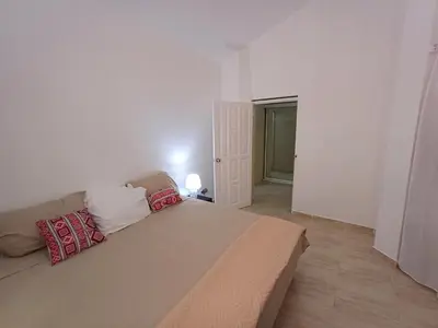 a bedroom with a large bed with two pillows on it at Linkzup Playa Laguna Villa in Sosúa