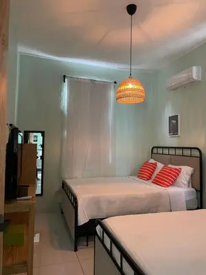 a bedroom with two beds and a chandelier at Casa Monte Verde in Las Galeras