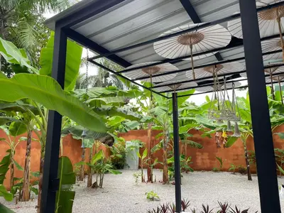 a greenhouse with plants and umbrellas at Casa Monte Verde in Las Galeras