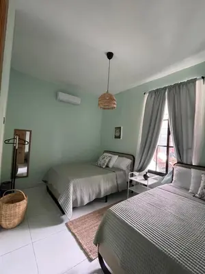 a bedroom with two beds and a window at Casa Monte Verde in Las Galeras