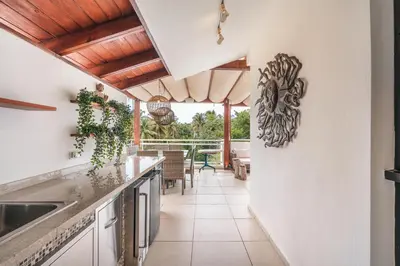 a kitchen with white walls and wooden ceilings at Unique gem penthouse in playa bonita in Las Terrenas