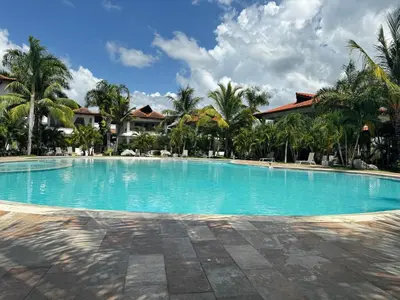 a large swimming pool in a resort with palm trees at Vista Bayahibe Paradise in Bayahibe