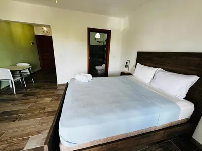 a bedroom with a large bed and a table at Vista Bayahibe Paradise in Bayahibe