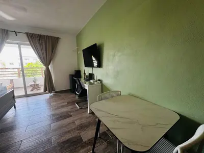 a living room with a table and a room with a window at Vista Bayahibe Paradise in Bayahibe