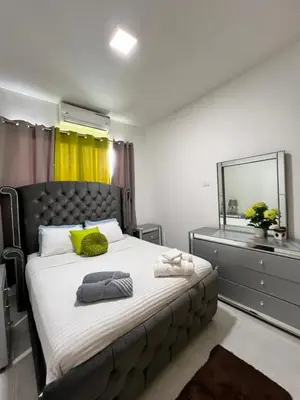 a bedroom with a large bed with a large mirror at Villa Angel in San Felipe de Puerto Plata
